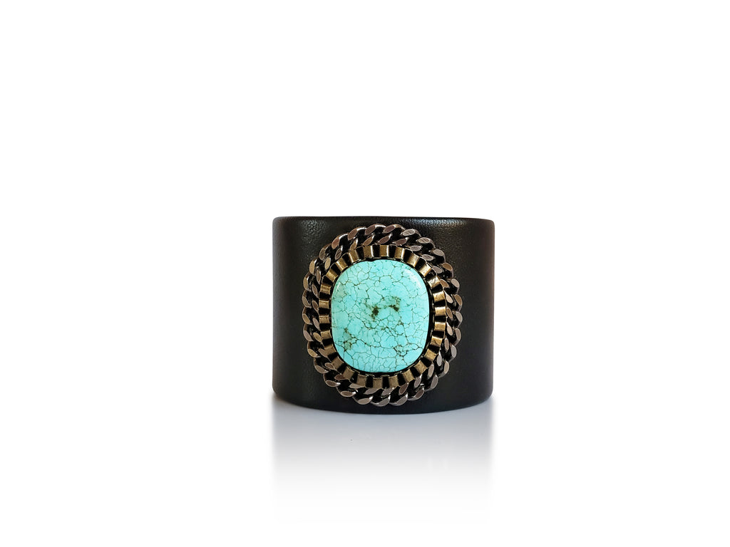 Black leather cuff with amazing turquoise stone central piece adorned bygunmetal and brass chains.
