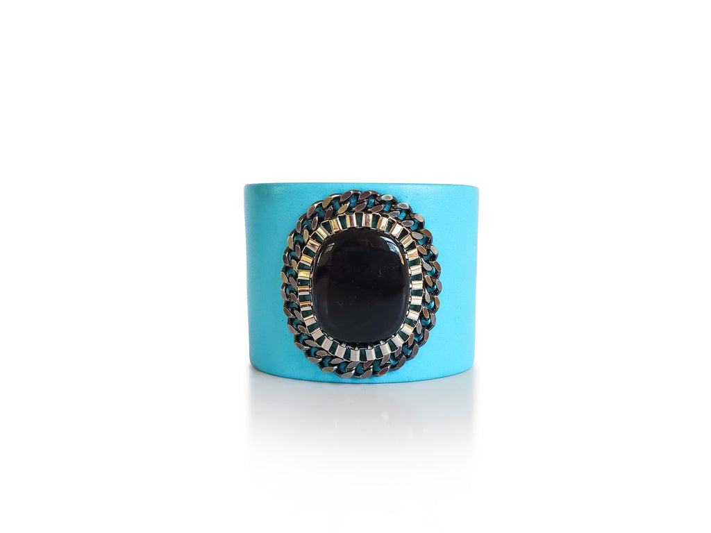 Turquoise leather cuff with onyx stone centerpiece and silver, gunmetal chains.