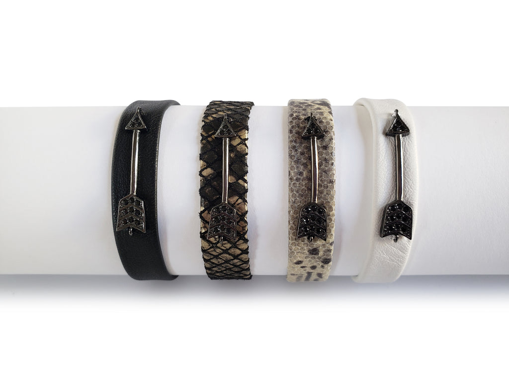 Magnetic black ,white, python, black and gold python leather bracelets ,0'5 inches wide with gunmetal micro pave sz arrovs.