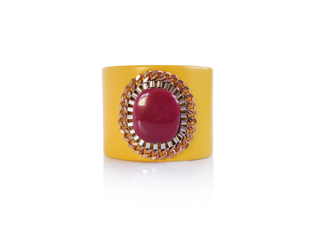 Yellow leather cuff with fuchsia aghate stone centerpiese , adorned by rose gold and silver chains.