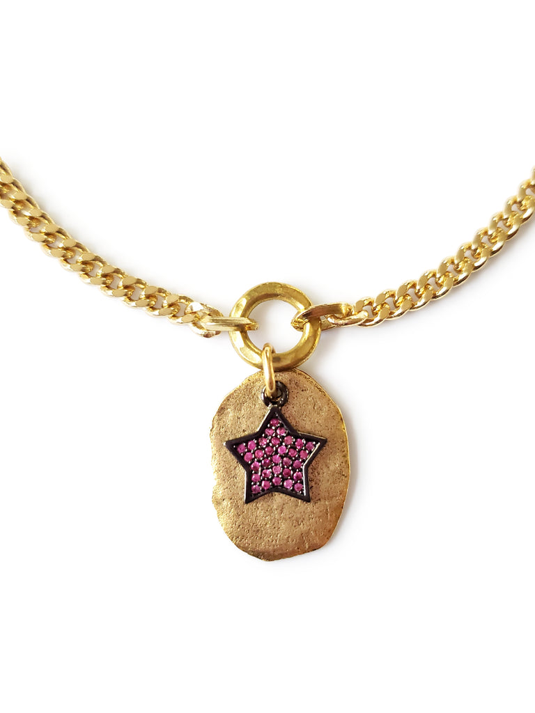 Gold disc with micro pave SZ star in gunmetal and fuchsia cubic zirconia.