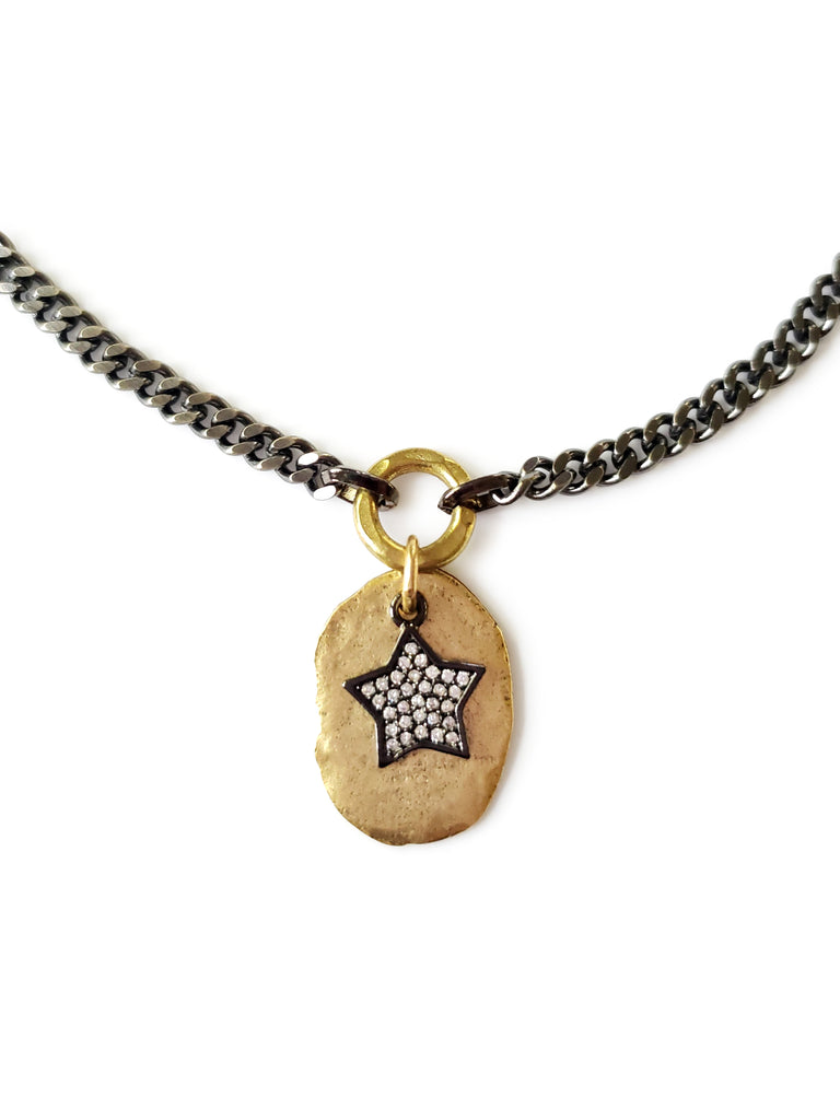 Gray chain necklace with gold disc with micro pave sz gunmetal star in crystal cubic zirconia.