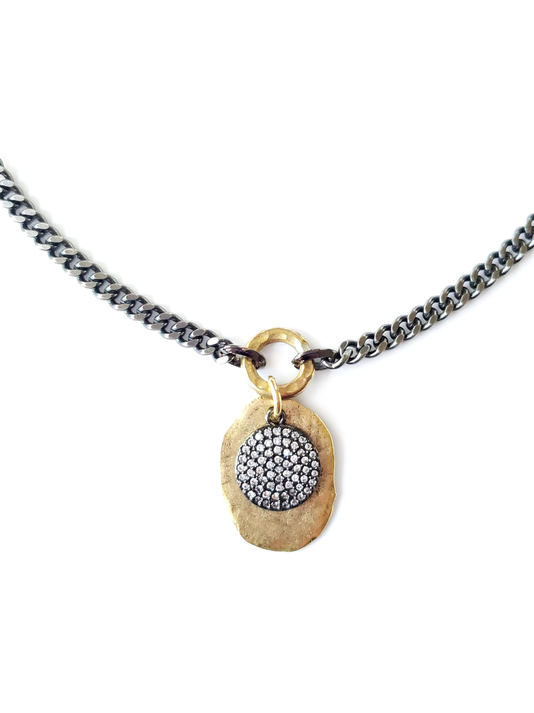 Gold color disc with gunmetal micro pave SZ coin in crystal cubic zirconia.