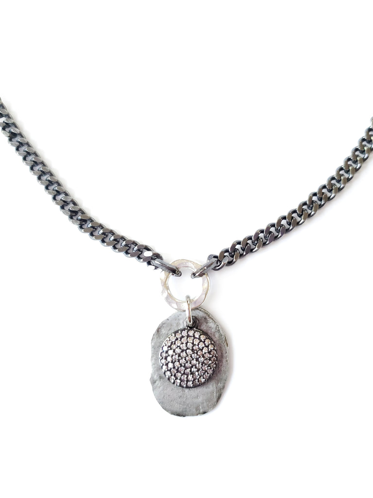 silver color disc with gunmetal micro pave SZ coin in crystal cubic zirconia.