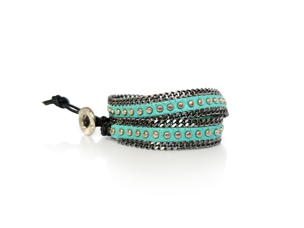Turquoise leather and  silver stud bracelet with gray chain edges and silver color button closure.